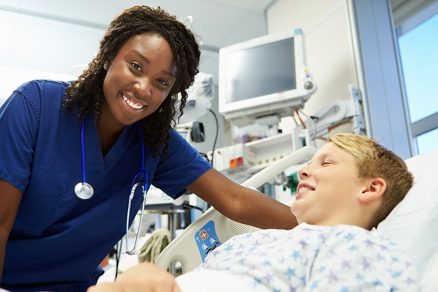 Nurse practitioner interacting with young male patient in the ER